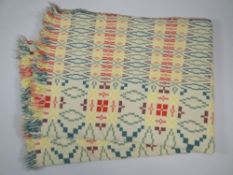 A WELSH BLANKET in geometric solid green, green flecked, yellow and red patterning, 205 x 145cms