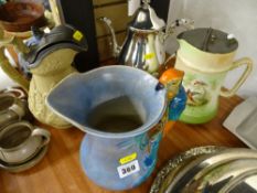 Victorian relief moulded pewter lidded jug, a Burleigh ware Art Deco parrot handled jug and one