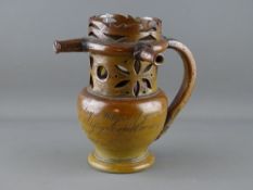 Circa 1820 salt glazed puzzle jug inscribed 'Mrs Bosworth, Come Gentleman and Try Your Skill, I'll