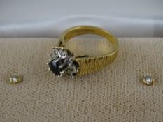 Pair of fourteen carat gold diamond stud earrings and a nine carat gold dress ring with peridot