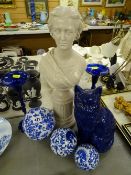 Composition head and shoulders bust on a plinth, blue pottery cat, three blue and white decorated
