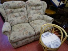 Light floral upholstered two seater couch and a single bamboo conservatory seat