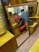 Large bevelled edge mirror with wooden frame and floral decoration