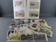 Album of vintage postcards, additional loose cards and an aluminium pocket container of unsorted