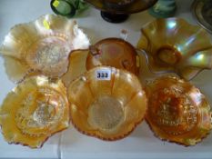 Six pieces of marigold carnival glassware