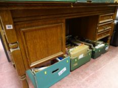 Oak? desk with single cupboard and three side drawers
