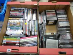 Box of mixed DVDs and a box of CDs