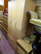 Modern three door wardrobe with two base drawers and a three drawer bedside cabinet