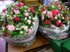 Two hanging baskets with artificial flowers