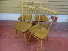 Set of four light wood Ercol stick back chairs