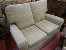 Compact two seater reversible cushion couch with woven texture upholstery