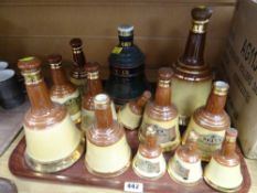 A tray of various sized Wade Bell's whisky decanters