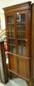 A good vintage oak standing corner cabinet, glazed top above a cupboard base & on raised feet