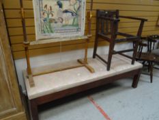 A low upholstered examination-style couch together with a wooden armchair (for restoration)