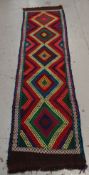 A multi-coloured Suzni runner, 289 x 66cms