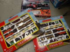 Two boxed children's train sets together with a boxed racing car set