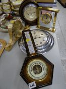 Three modern clocks & two barometers