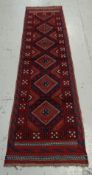 A red & blue patterned Meshwani runner, 254 x 63cms