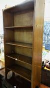 A tall narrow oak bookcase