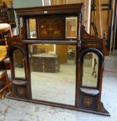 An elaborately decorated early twentieth century mahogany overmantel mirror with upper & lower