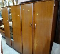 A vintage G-Plan bedroom suite comprising large mirror wardrobe, small wardrobe, mirror dressing