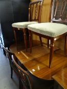 A reproduction mahogany extending dining table & four matching chairs