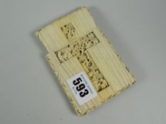 An ornately carved ivory card case (distressed) with ornate cruciform carving