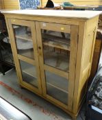 A vintage light oak glass two-door bookcase