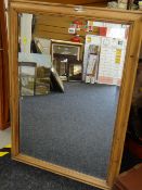 A pine framed bevel wall mirror