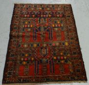 A blue & red patterned old Baluchi rug, 124 x 92cms