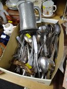A box of stainless steel flatware, pewter tankard etc