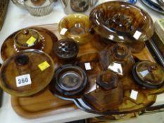 A tray of vintage amber glass items including rose bowl, dressing table set etc
