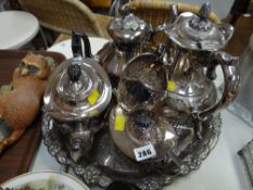 A matching three-piece EPNS teaset together with teapot & water jug on a circular tray