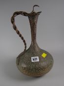 A Middle Eastern copper & etched decorated snake-handled ewer