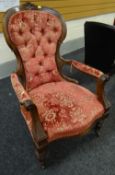 An antique possibly walnut armchair with carved decoration & spoon back