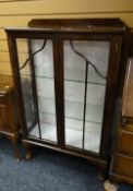 A vintage mahogany glass door display cabinet on ball & claw feet