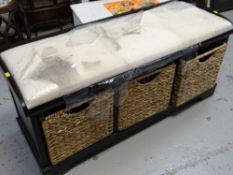A black ash cushioned bench with wicker storage basket bottom