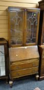 A vintage oak bureau bookcase