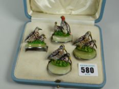 A part-set of four painted bronze menu holders, each modelled as a different game bird on an