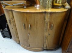A good mid-twentieth century bow fronted railback light oak sideboard with carving & three-