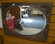 A vintage metal & decorated bevel wall mirror