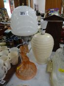 An Art Deco-style pink glass lamp together with another