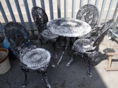 A cast metal painted circular patio table & chairs (outside)