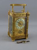 A FRENCH GILT BRASS ALARM CARRIAGE CLOCK having a circular enamel dial and subsidiary alarm dial