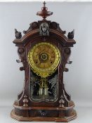 A 19th CENTURY WALNUT CASED ANSONIA MANTEL CLOCK with lower central drawer, 63 cms high overall