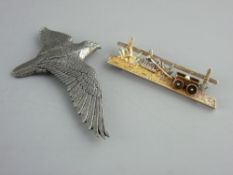 A FOURTEEN CARAT GOLD BROOCH and one other in pewter, the gold example as a horse pulling a cart