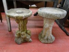 TWO RECONSTITUTED STONE BIRD BATHS on naturalistic bases, 54 and 57 cms high, 45 and 39 cms