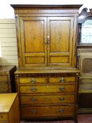 A GEORGIAN OAK & CROSSBANDED MAHOGANY PRESS CUPBOARD, the panelled top doors with Sheraton shell