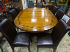 A FRENCH STYLE REPRODUCTION WALNUT DINING TABLE on substantial acanthus leaf decorated supports