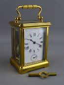 AN E G L, PARIS BRASS CASED ALARM CARRIAGE CLOCK, the white dial set with Roman numerals and